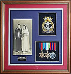 Framed medal display with badge, medals and photograph